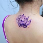 Watercolor lotus flower tattoo on the back