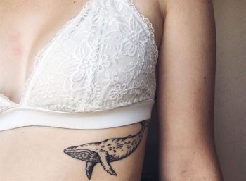 Whale tattoo on the left rib cage