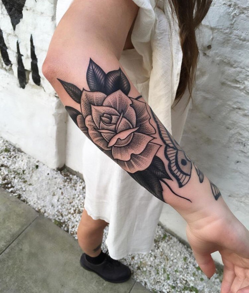 White rose tattoo on the forearm