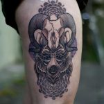 Wolf and antler tattoo on the thigh
