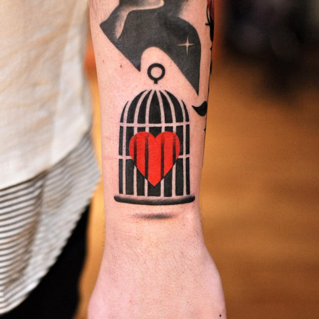 Bird cage with a heart tattoo