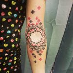 Black and red mandala tattoo with plus signs