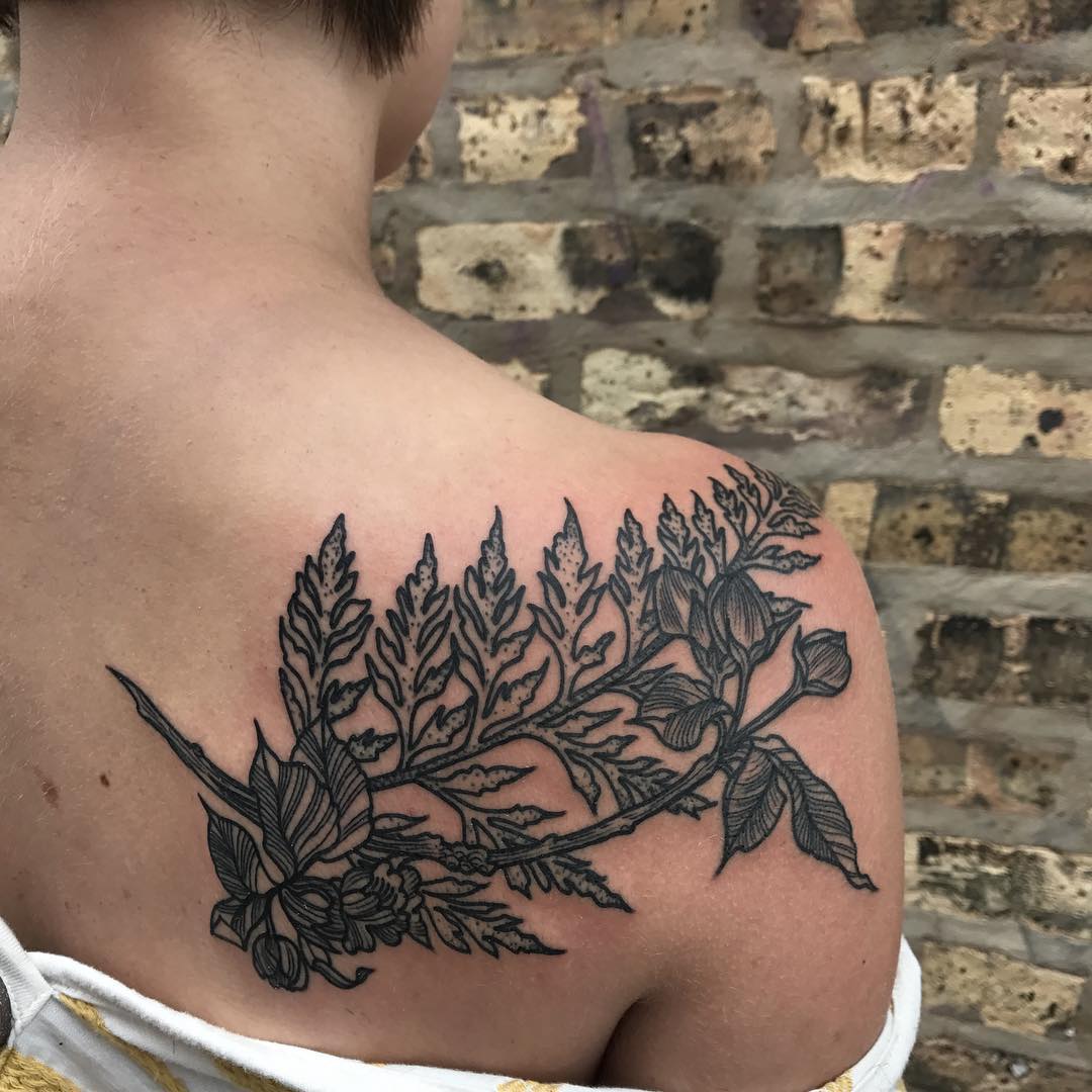 Black branch tattoo on the shoulder blade