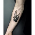 Black crystal cluster tattoo on the forearm