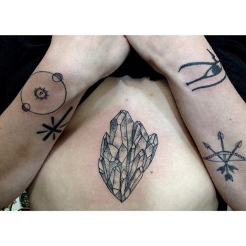 Black crystal sternum tattoo