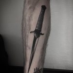 Black dagger tattoo on the calf