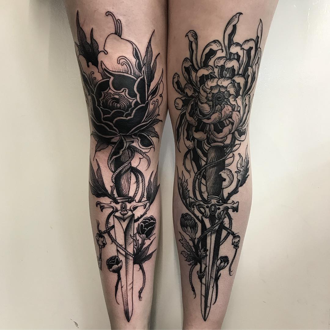 Black daggers and peony tattoos on legs