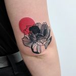 Black flower and red moon tattoo