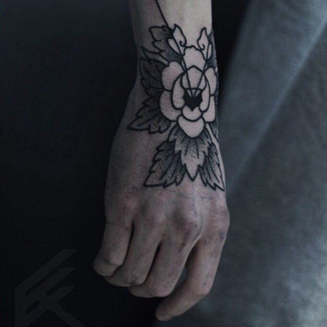 Black flower hand tattoo