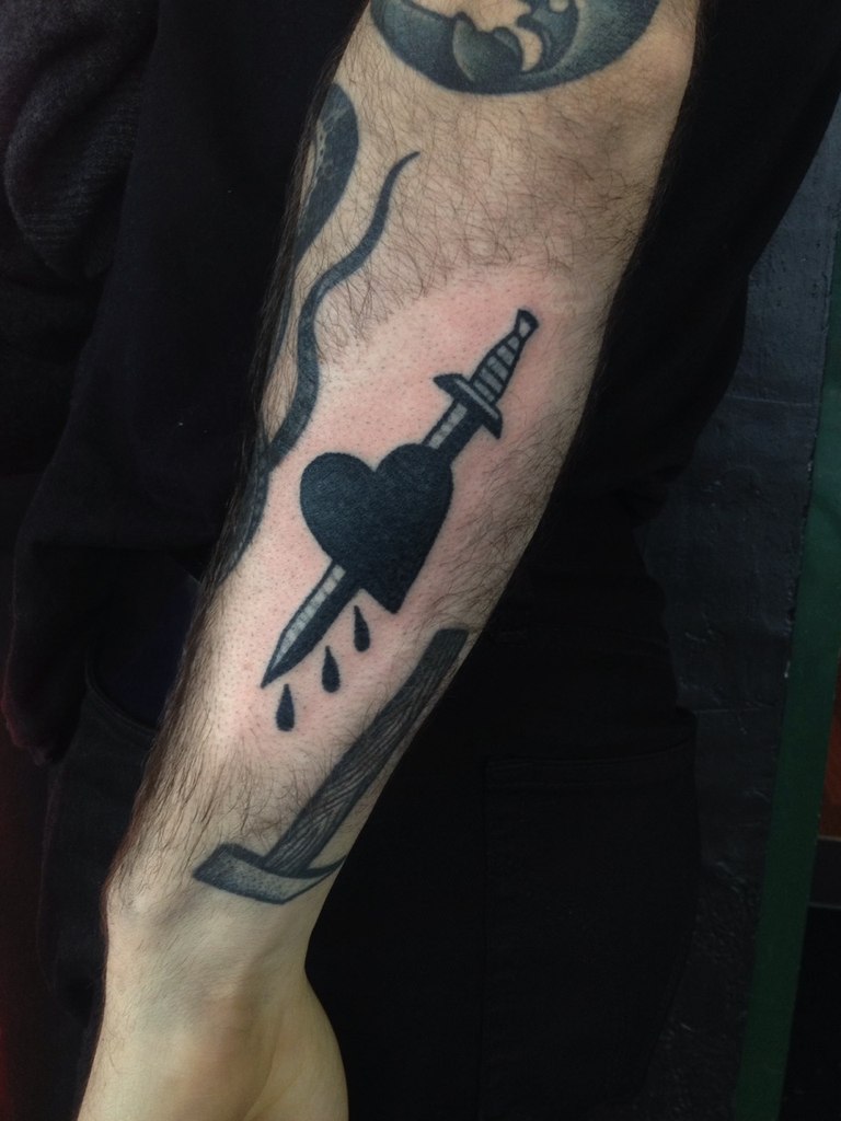 Black heart and sword tattoo