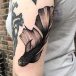 Black koi fish tattoo on the arm