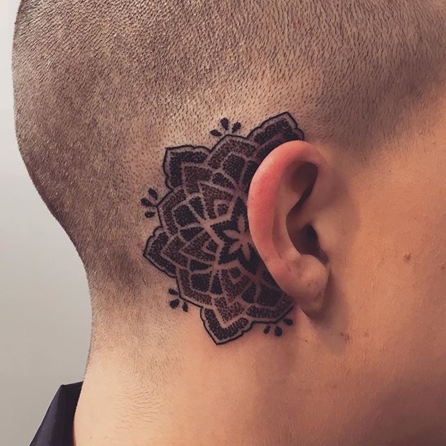 Black mandala tattoo behind the ear