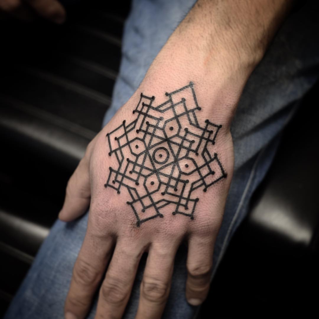 Black ornamental pattern hand tattoo