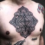 Black pattern chest tattoo