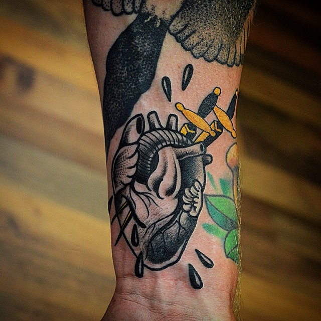Black pierced heart tattoo