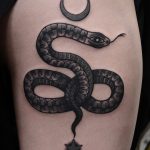 Black snake and crescent moon tattoo