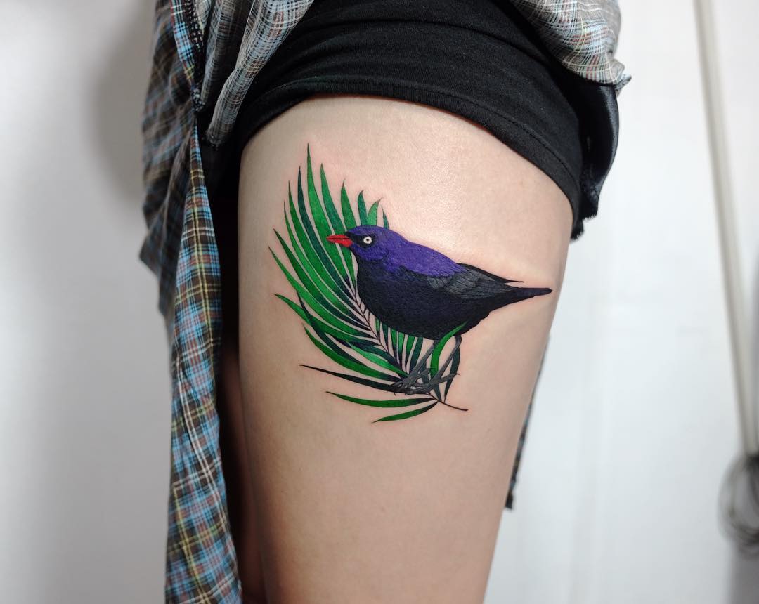 Blackbird on a palm leaf tattoo