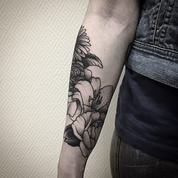 Blackwork floral forearm tattoo