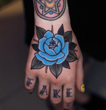 Blue rose hand tattoo