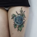 Blue rose tattoo on the thigh