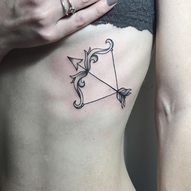 Bow And Arrow Tattoo On The Rib Cage - Tattoogrid.Net
