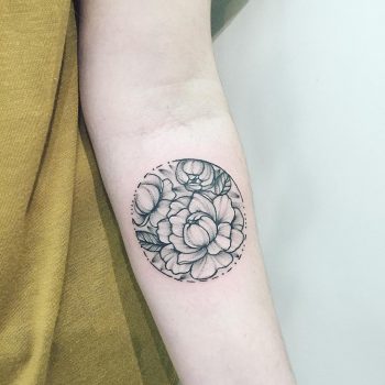 Circular black and grey flower tattoo
