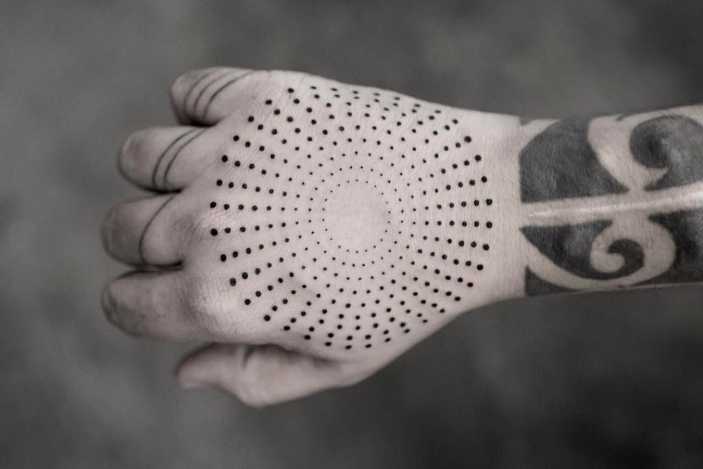 Circular dotted tattoo on the hand