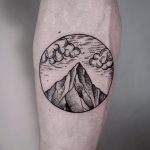 Circular mountain and clouds tattoo