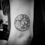 Circular wave and sun tattoo