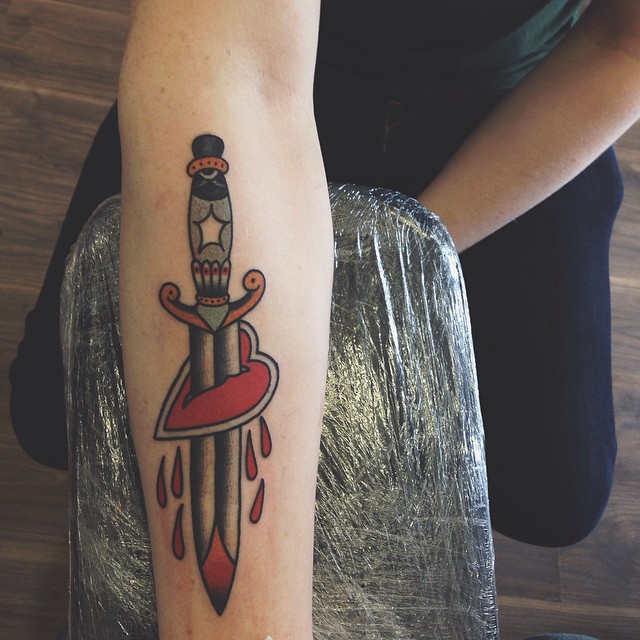 Classy dagger stabbed heart tattoo