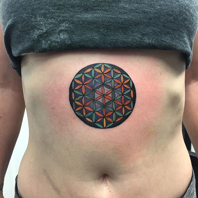 Colorful flower of life tattoo on the belly