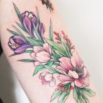Colorful flowers tattoo on the arm