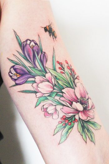 Colorful flowers tattoo on the arm