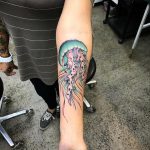 Colorful jellyfish tattoo on the forearm