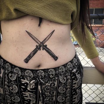 Crossed knives tattoo