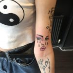 Crying face tattoo