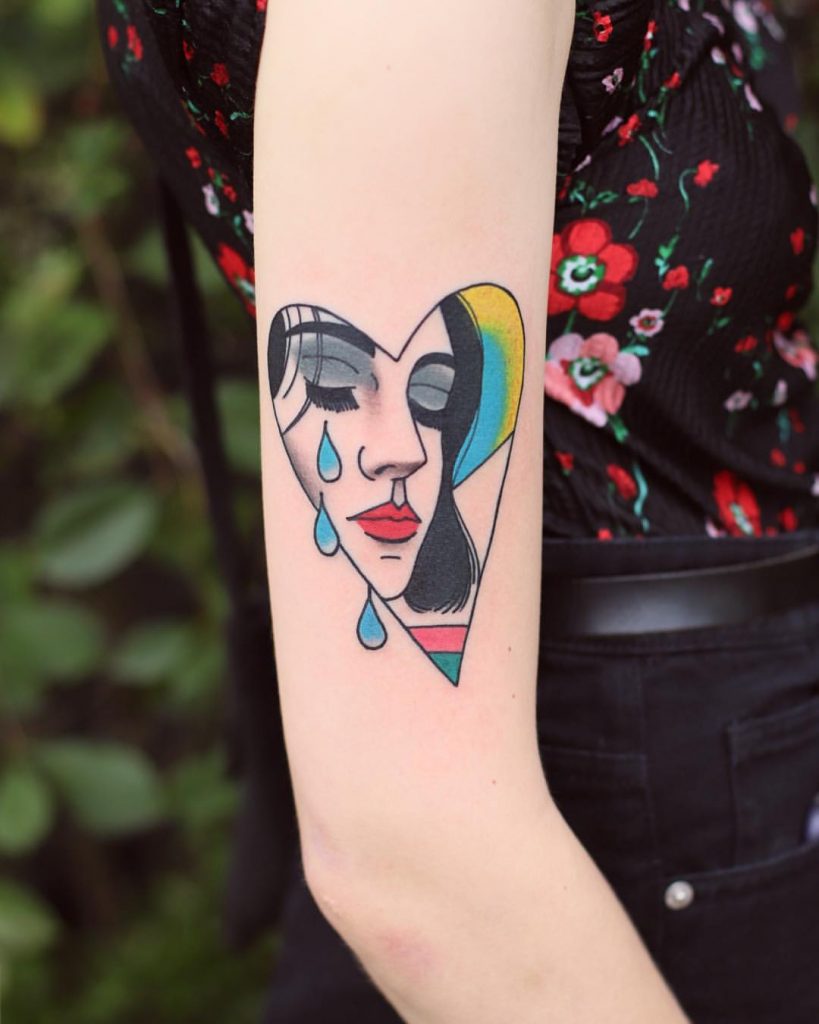 Crying woman in a heart tattoo