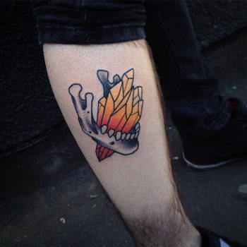 Crystal and human jaw tattoo