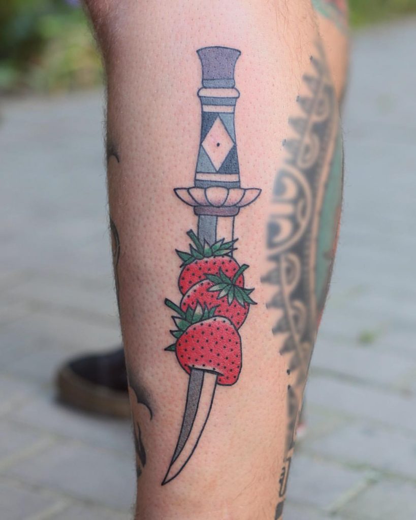 Dagger stabbed strawberries tattoo