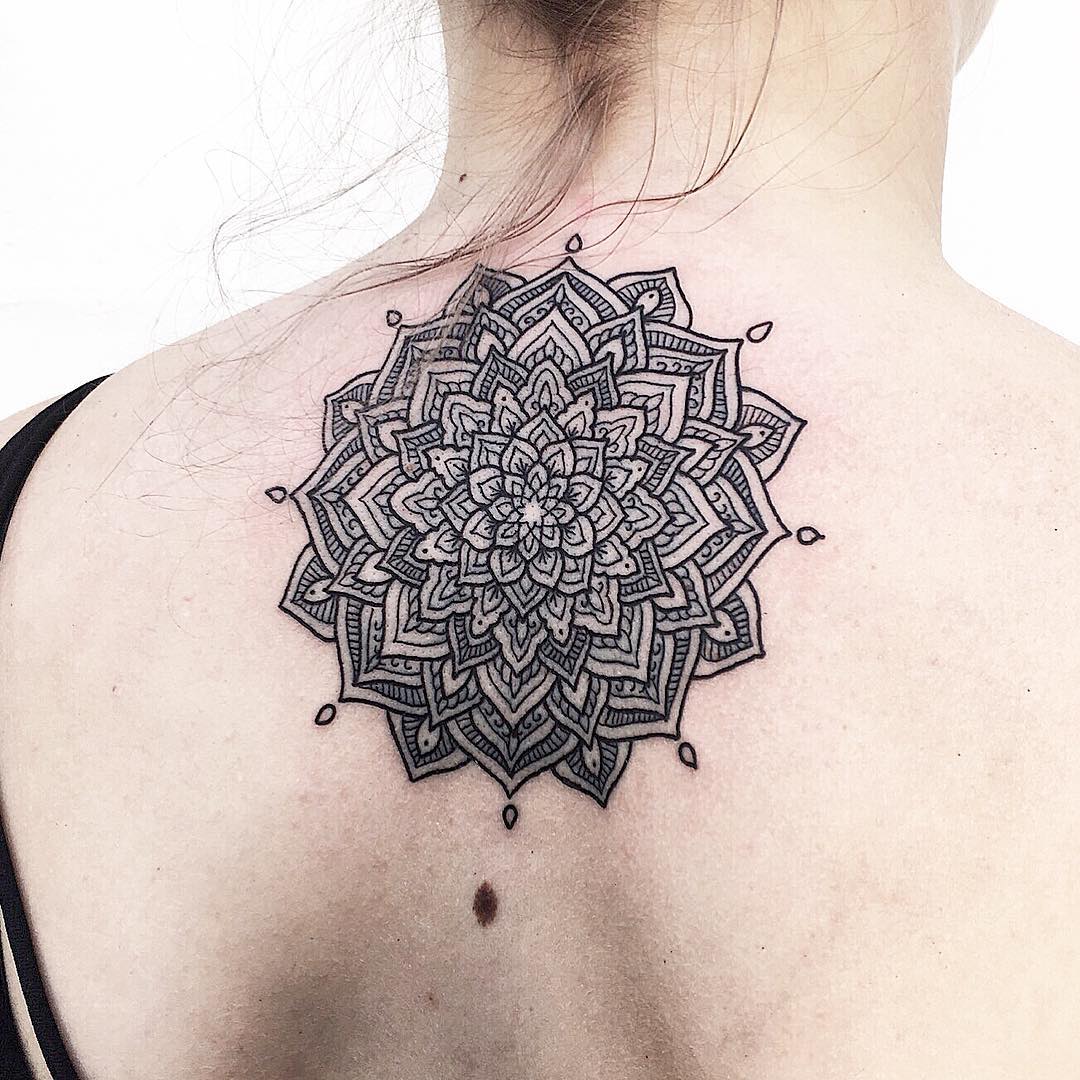 Delicate black mandala tattoo on the back