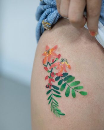 Delicate colorful flower tattoo