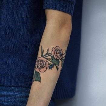 Delicate rose tattoo on the forearm