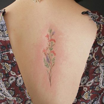 Delicate wildflower tattoo on the back