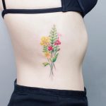 Delicate wildflowers bouquet tattoo on the side