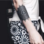 Detailed black mandala tattoo