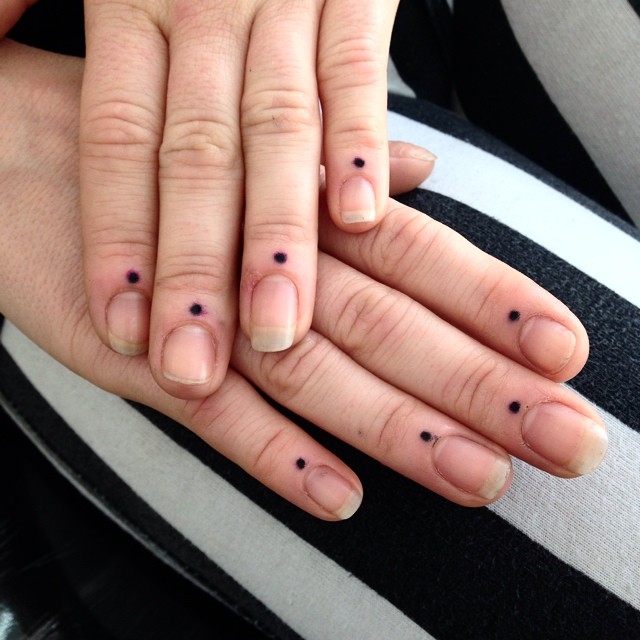 Dot tattoos on fingers