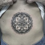 Dotwork style floral mandala belly tattoo