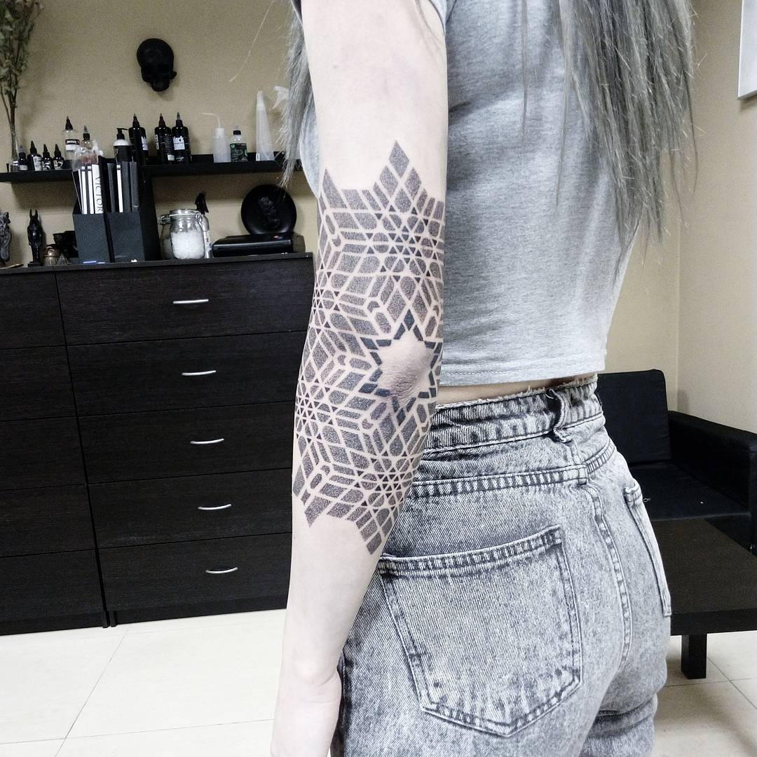 Dotwork style geometric arm tattoo