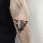 Dotwork style geometric tattoo on the forearm