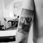 Dotwork tattoo of a hut in the mountains